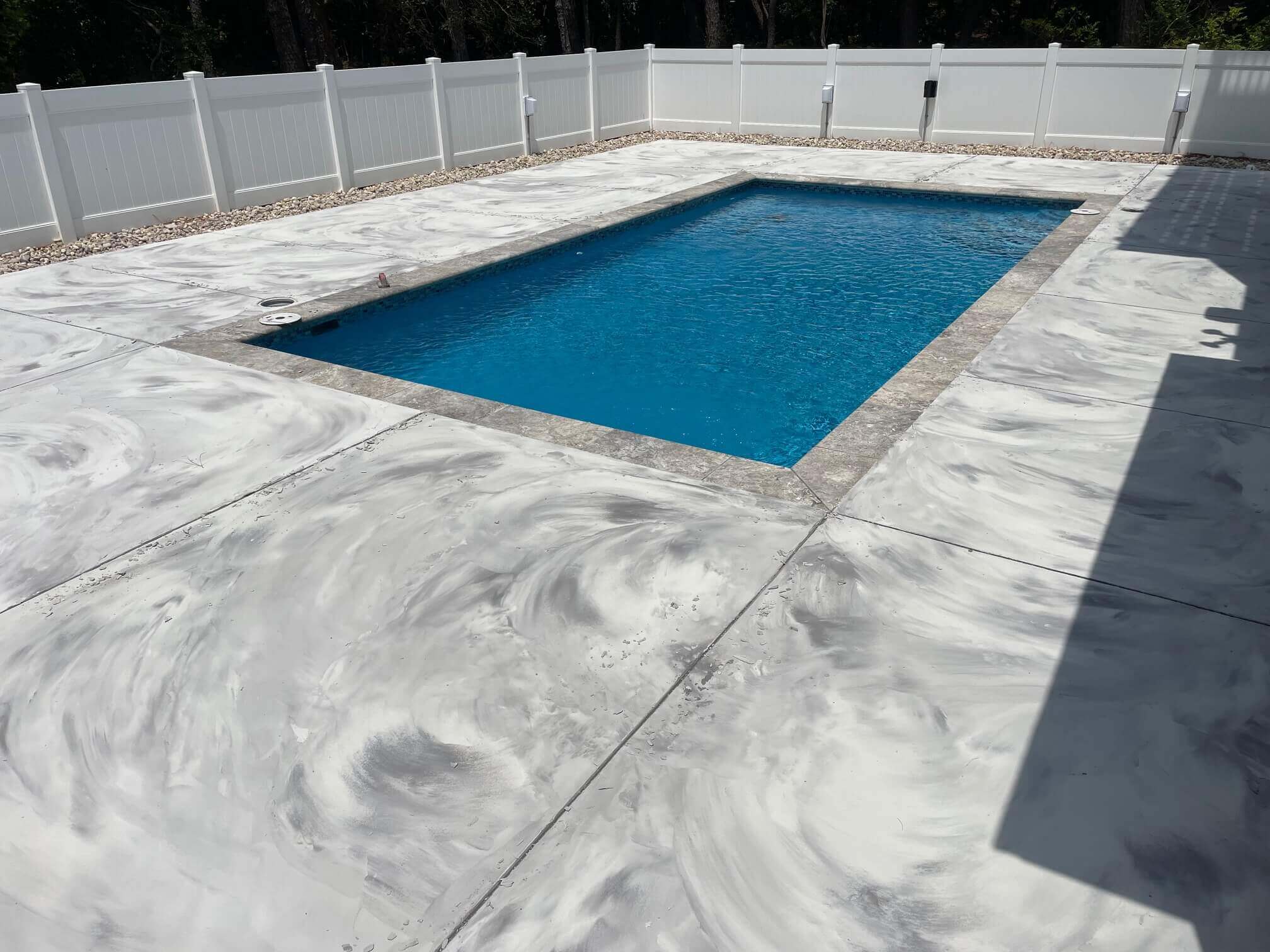 A pool deck with an acrylic cement coating. The pool deck is located in the Outer Banks.