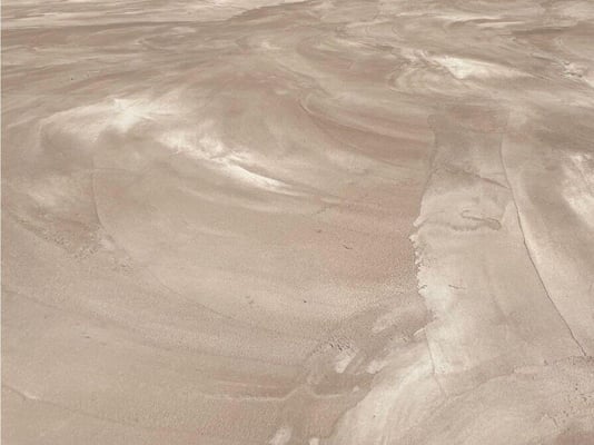 A close-up look at the texture of acrylic cement installed on outdoor concrete.
