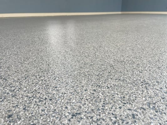 A close-up of a paint chip epoxy floor.