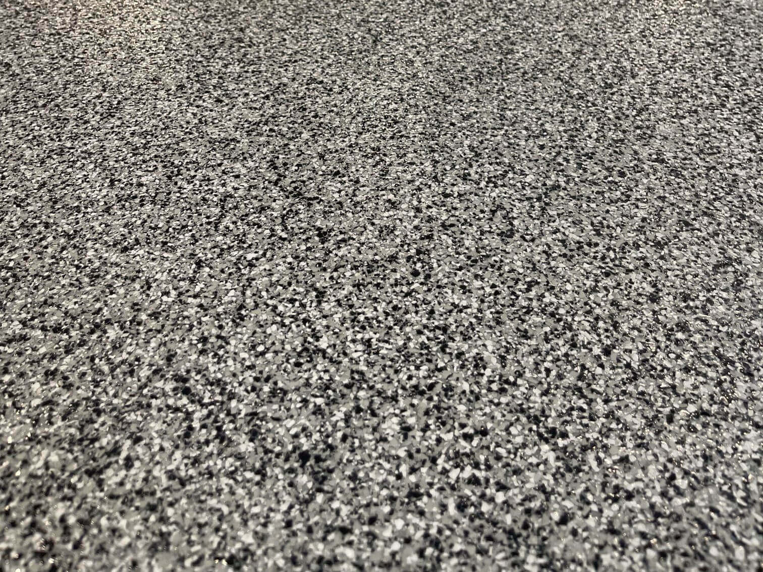 The floor of a house basement in Huntingdon, Pennsylvania. This floor was coated with a paint chip epoxy system.