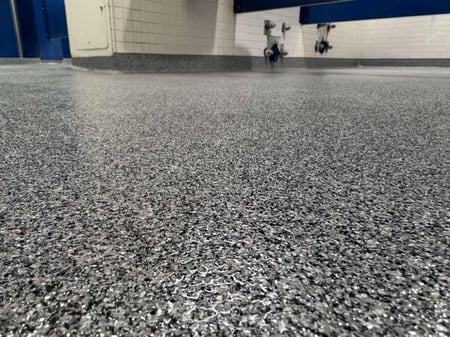 A close-up of the paint chip epoxy floor system installed in this Mercersburg bathroom by Elite Floor Coatings.