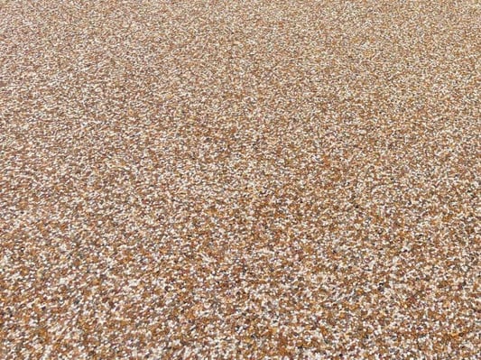 A closer look at river rock epoxy coating on outdoor concrete.