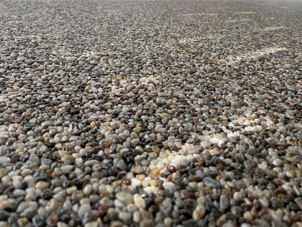 A closer look at river rock epoxy coating on outdoor concrete.