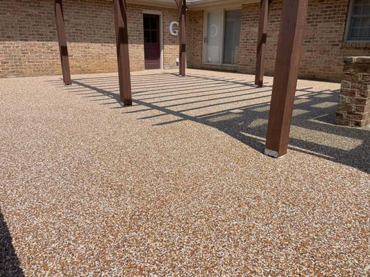 A patio in Hagerstown, Maryland, coated with a brown-red river rock epoxy.