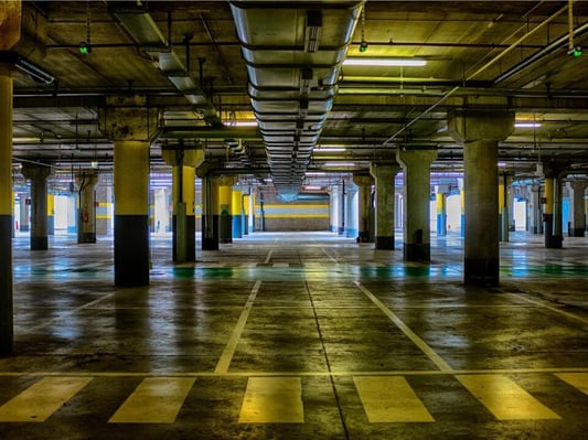 A parking garage with directions in the floor.