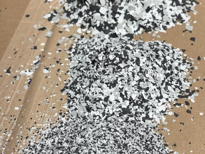 Piles of paint flakes for paint chip epoxy systems, in one-sixteenth, one-eighth, and one-quarter inch sizes.