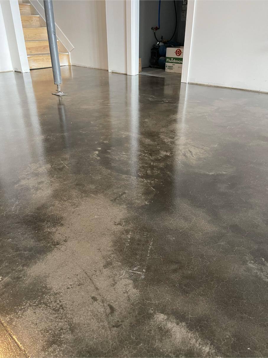 A close-up on the grind and seal concrete floor in a Marion basement.