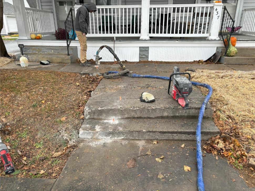Concrete sidewalk and stairs repaired with polyjacking foam.
