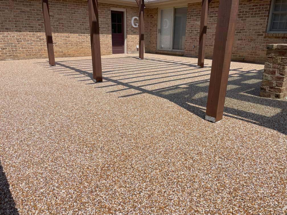 A patio in Hagerstown, Maryland, coated with a brown-red river rock epoxy.