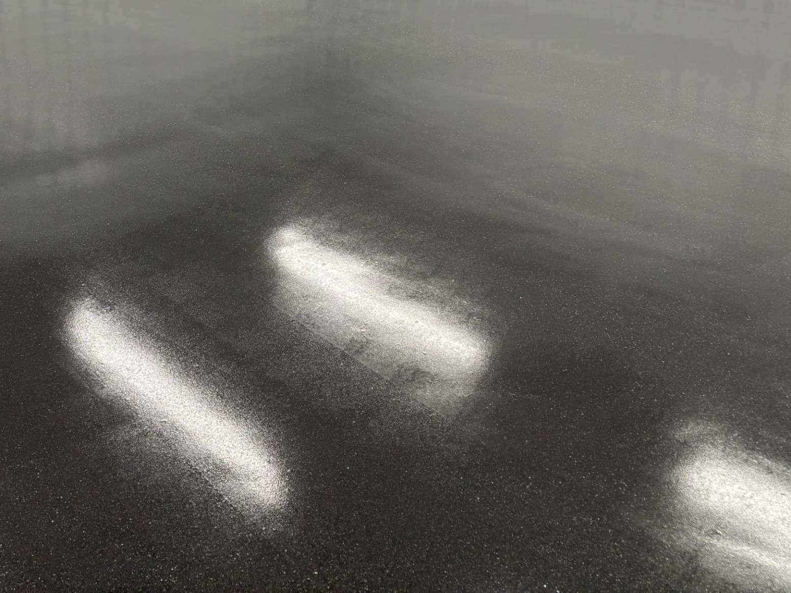 A close-up look at black terrazzanite floor.